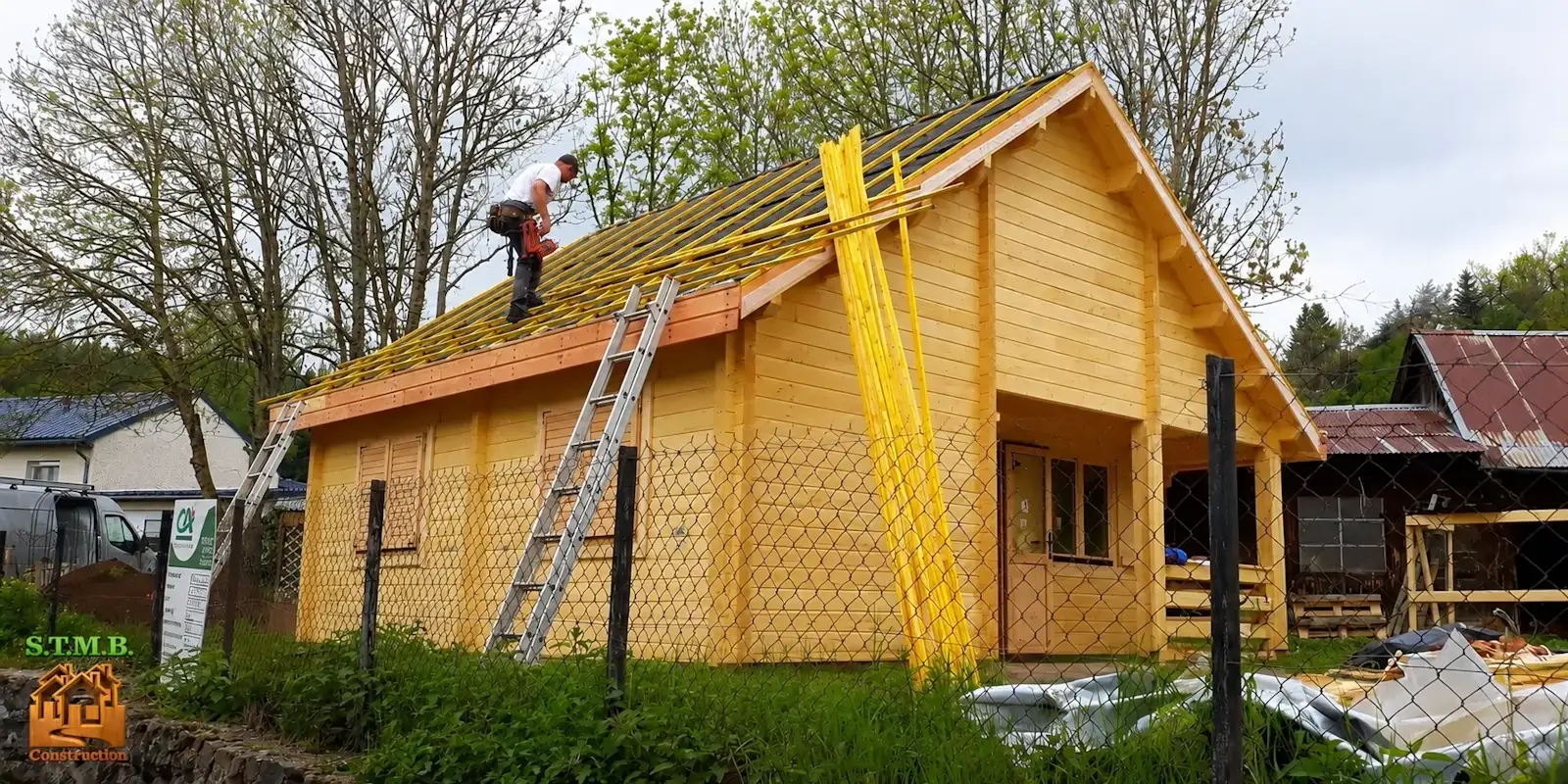 Équipe STMB Construction réalisant le montage d'un chalet en bois avec pose de la toiture sur un chantier en France